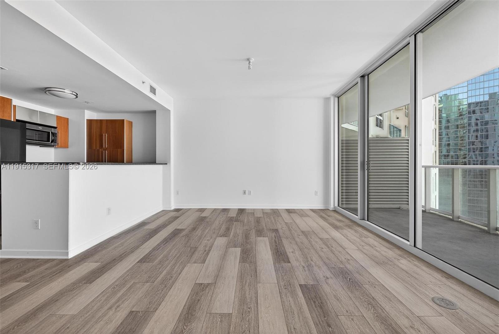 300 South Biscayne Boulevard, Unit T2407 Miami, FL 33131 - Photo 19 of 39 a view of a room with wooden floor and window