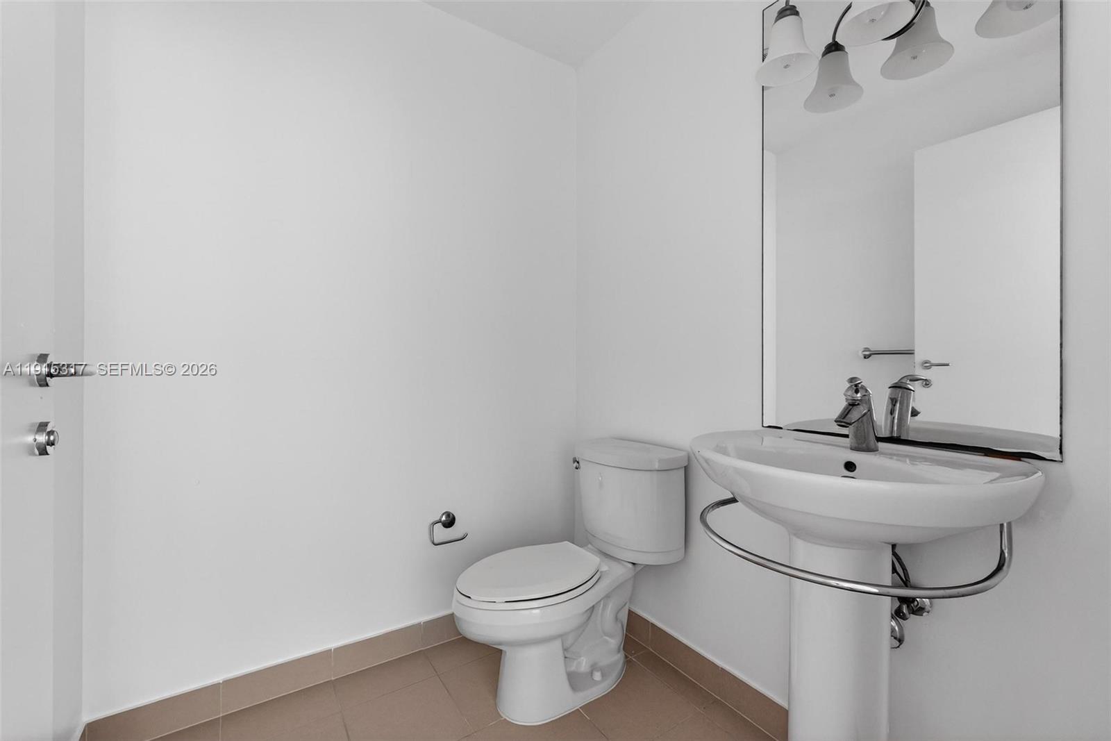 300 South Biscayne Boulevard, Unit T2407 Miami, FL 33131 - Photo 24 of 39 a bathroom with a toilet sink and mirror