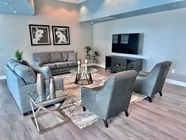 a view of a dining room with furniture and wooden floor