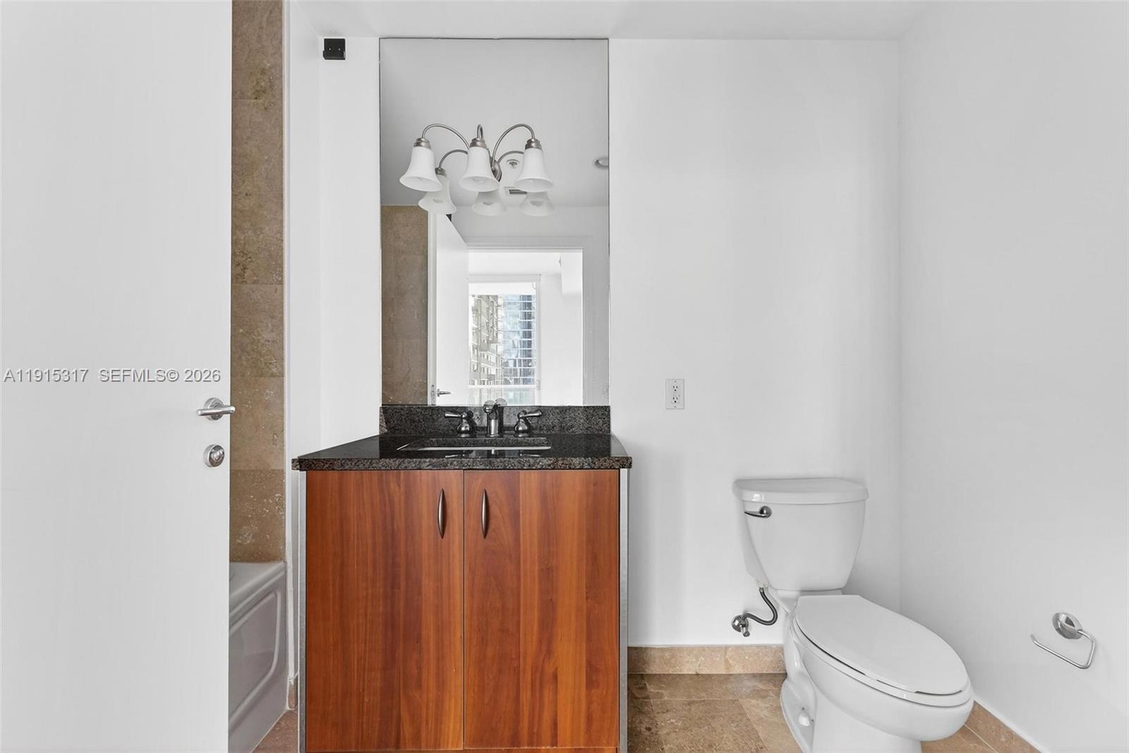 300 South Biscayne Boulevard, Unit T2407 Miami, FL 33131 - Photo 30 of 39 a bathroom with a toilet a sink and a mirror