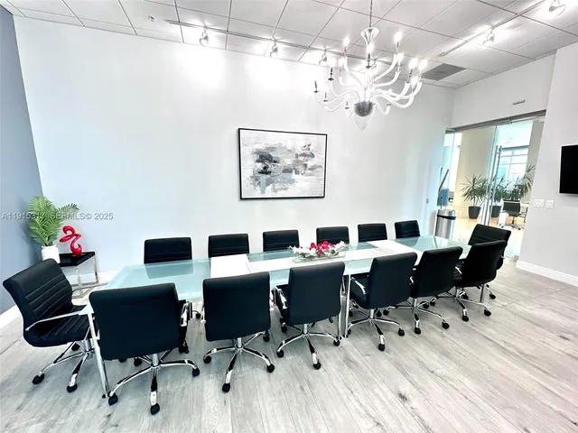 a kitchen with a sink and a stove with wooden floor