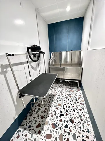 a living room with couches a coffee table and a piano with wooden floor