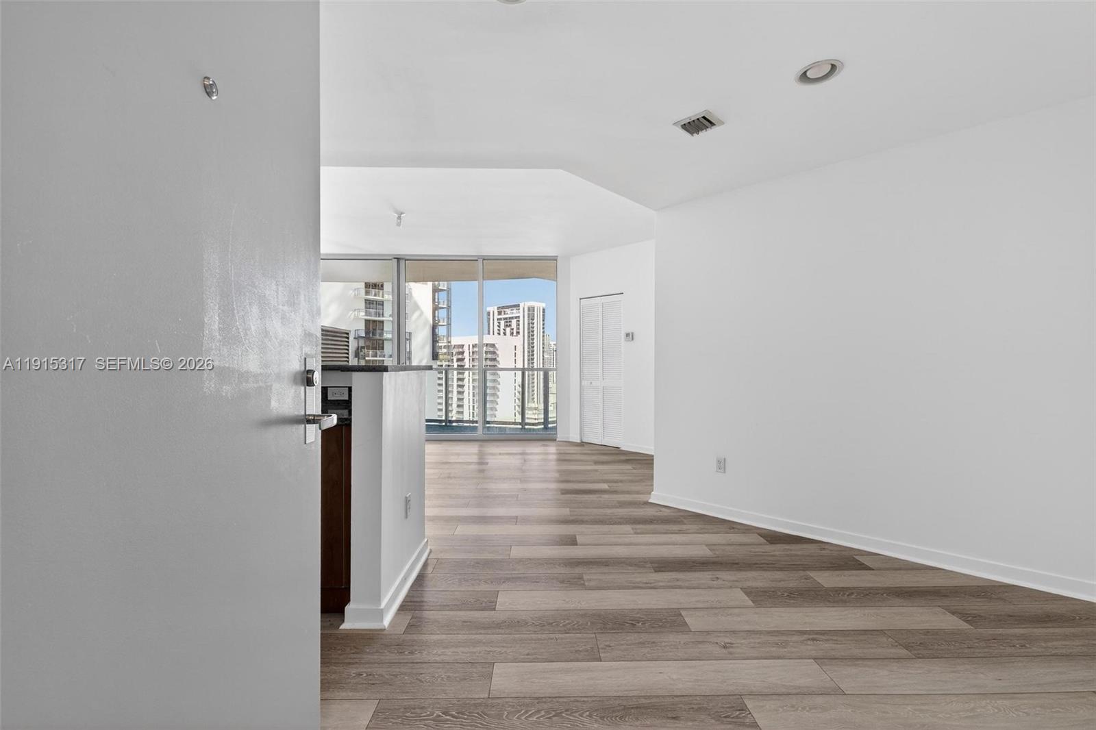 300 South Biscayne Boulevard, Unit T2407 Miami, FL 33131 - Photo 8 of 39 a view of a hallway view with wooden floor and staircase