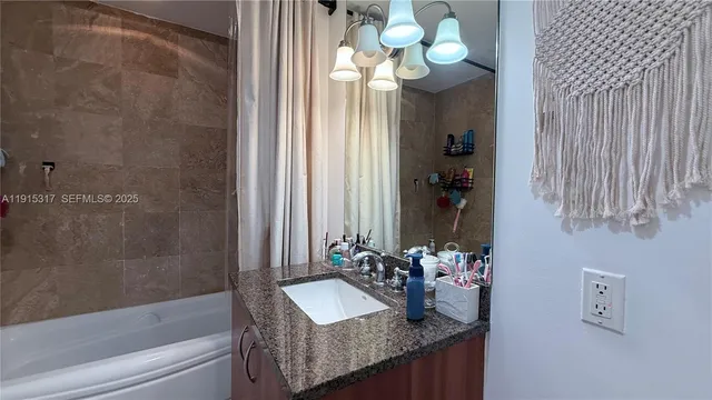 a bathroom with a granite countertop sink a toilet and a mirror