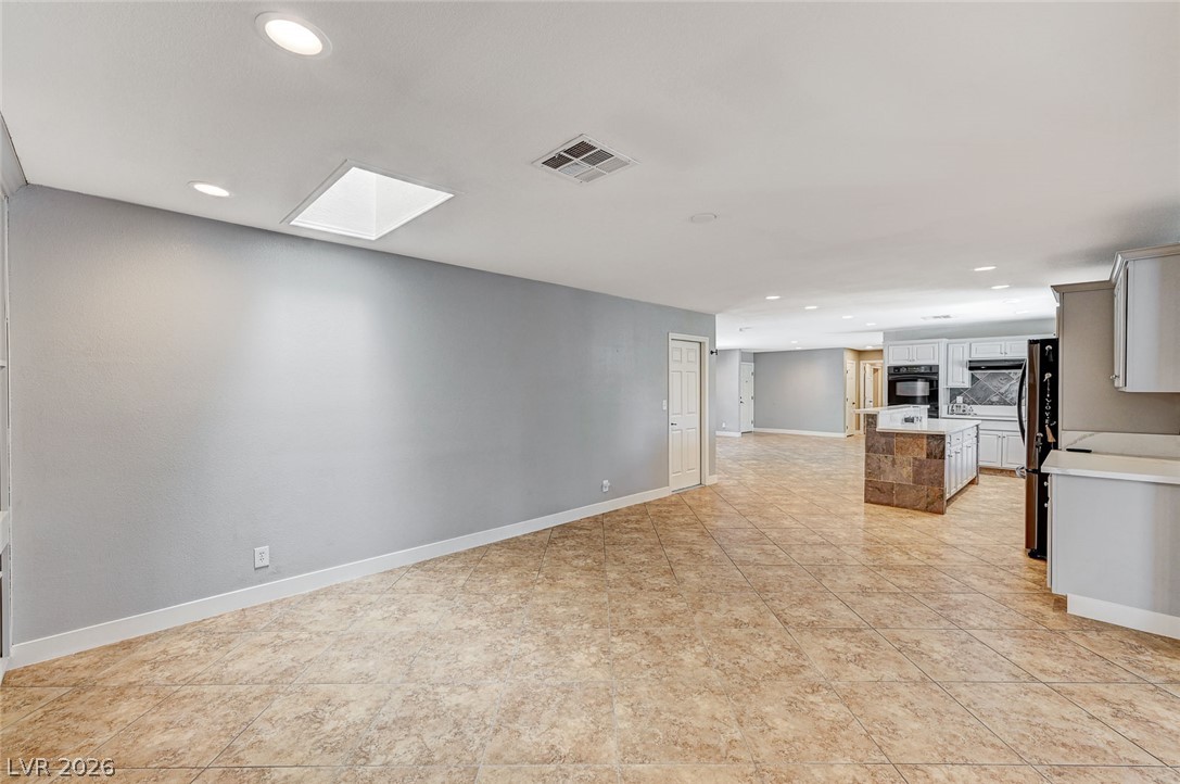 4153 Woodcrest Road Las Vegas, NV 89121 - Photo 58 of 58 An open floorplan seamlessly connects this versatile living space to a well-appointed kitchen.