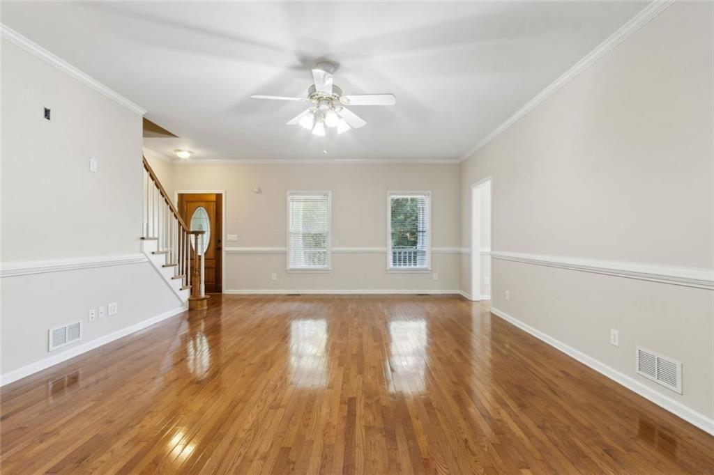 2651 West Rock Quarry Road Northeast Buford, GA 30519 - Photo 11 of 77 a view of an empty room with wooden floor and a window