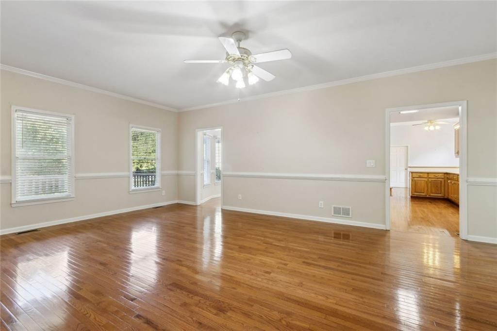 2651 West Rock Quarry Road Northeast Buford, GA 30519 - Photo 12 of 77 a view of a livingroom with wooden floor and a ceiling fan