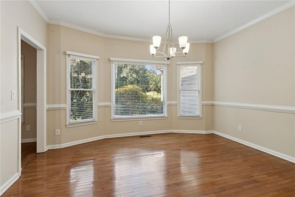 2651 West Rock Quarry Road Northeast Buford, GA 30519 - Photo 14 of 77 a view of an empty room with wooden floor and a window
