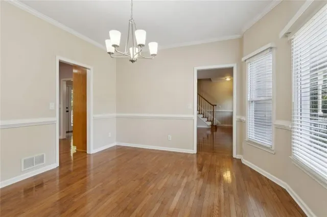 an empty room with a window and a ceiling fan