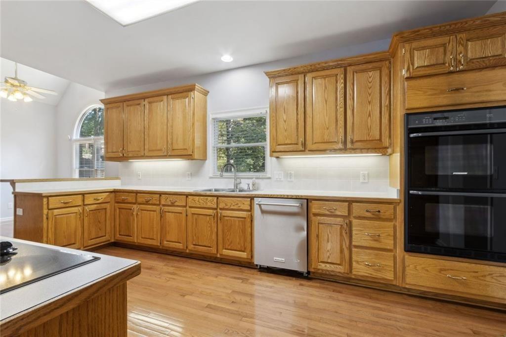 2651 West Rock Quarry Road Northeast Buford, GA 30519 - Photo 17 of 77 a kitchen with stainless steel appliances granite countertop a stove a sink and a microwave