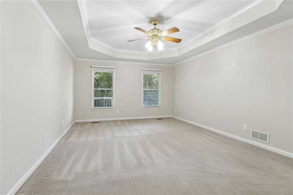 2651 West Rock Quarry Road Northeast Buford, GA 30519 - Photo 34 of 77 an empty room with a window and a ceiling fan