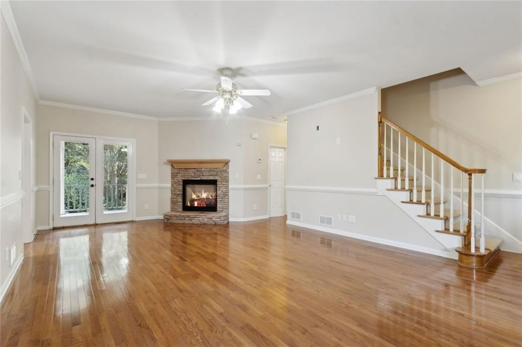 2651 West Rock Quarry Road Northeast Buford, GA 30519 - Photo 9 of 77 a view of an empty room with wooden floor fireplace and a window