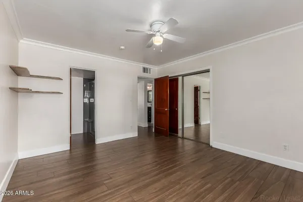 a view of an empty room with wooden floor