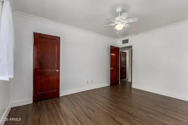 a view of an empty room with wooden floor