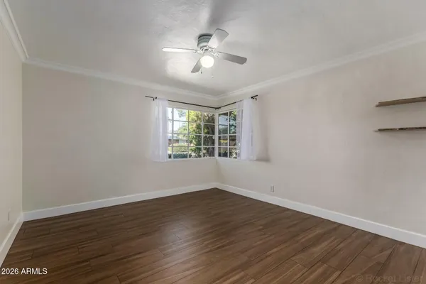 wooden floor in an empty room with a window