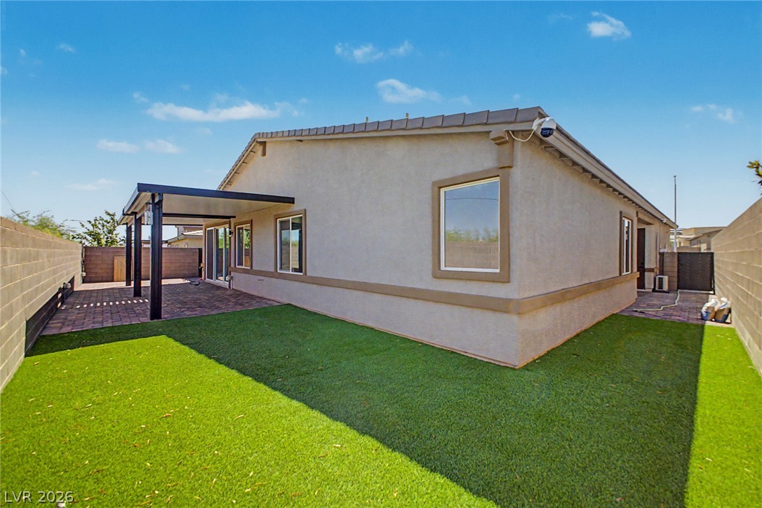 226 Augusta Ridge Henderson, NV 89015 - Photo 31 of 47 This outdoor space features artificial turf and a covered patio, perfect for relaxation and entertaining.