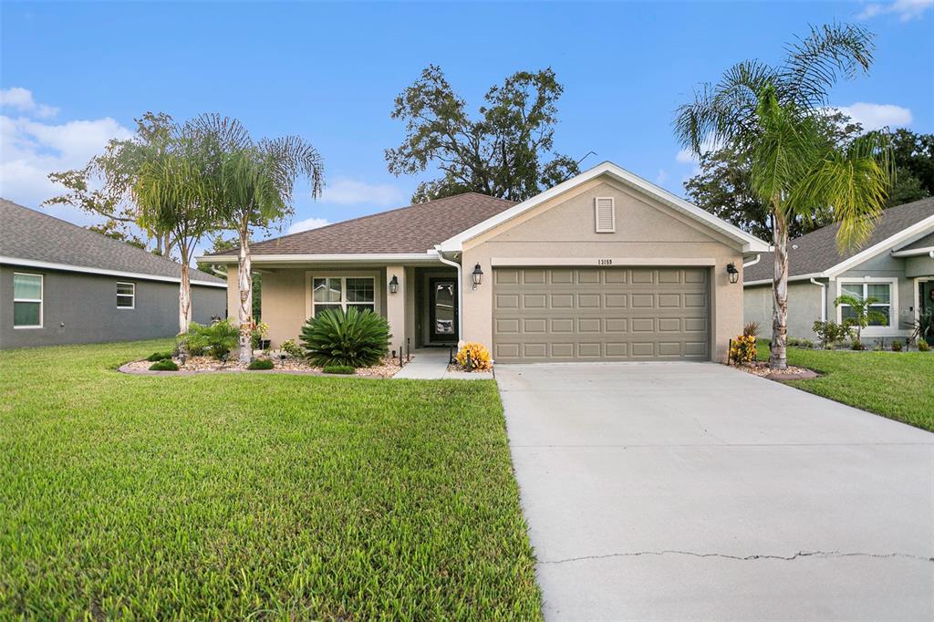 a front view of a house with a yard and garage