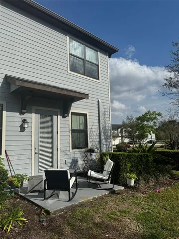 a backyard of a house with outdoor seating