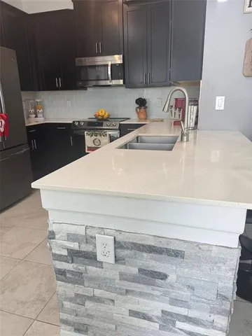 a close view of sink and cabinets
