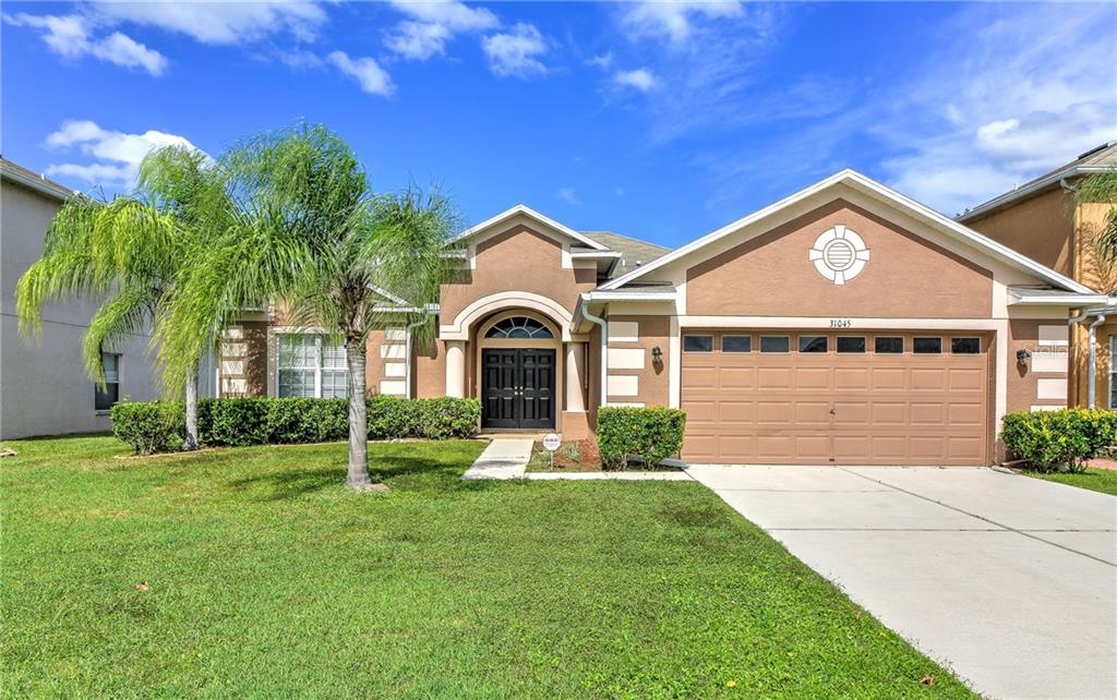 31045 Bridgegate Drive Wesley Chapel, FL 33545 - Photo 1 of 1 a front view of a house with garden