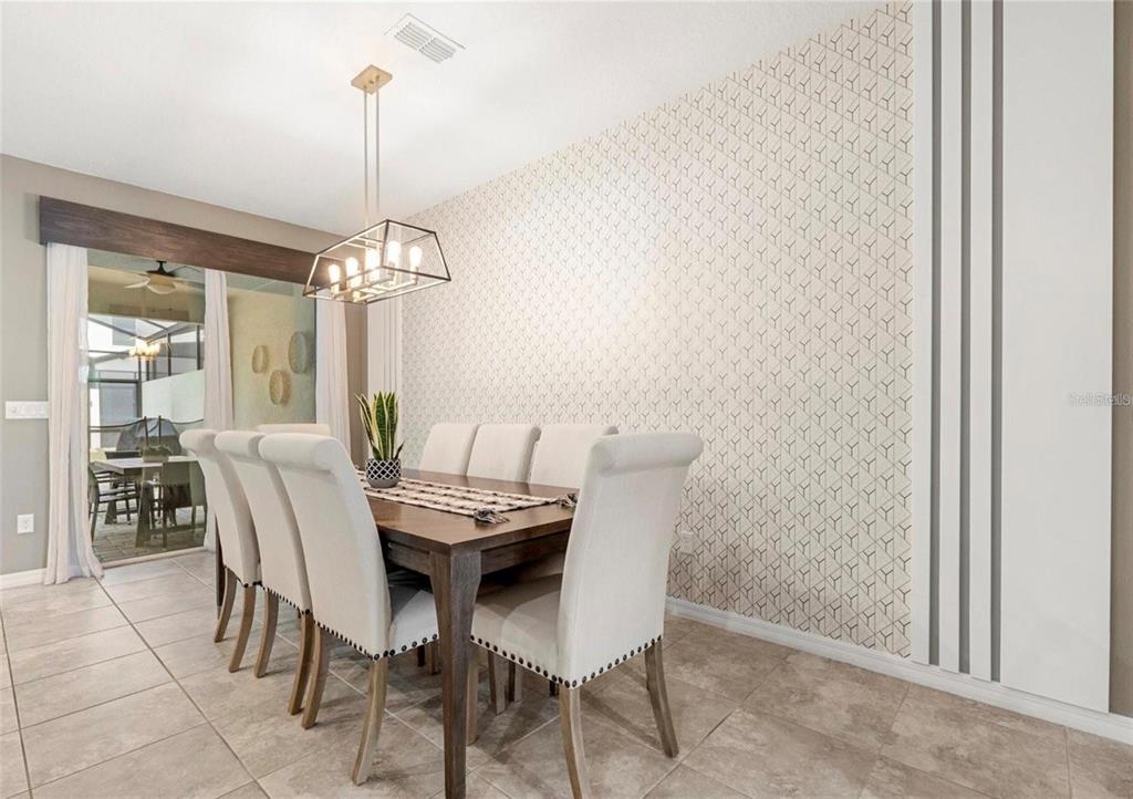 2163 Copper Bell Place Kissimmee, FL 34747 - Photo 12 of 41 a view of a dining room with furniture and chandelier