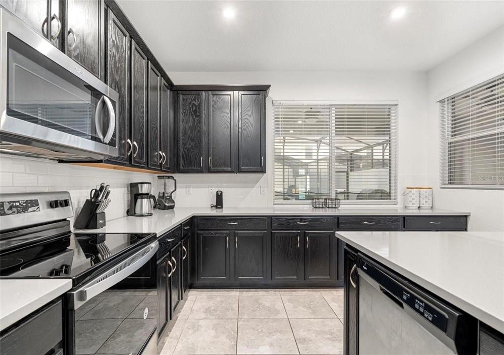 2163 Copper Bell Place Kissimmee, FL 34747 - Photo 17 of 41 a kitchen with a sink appliances and cabinets