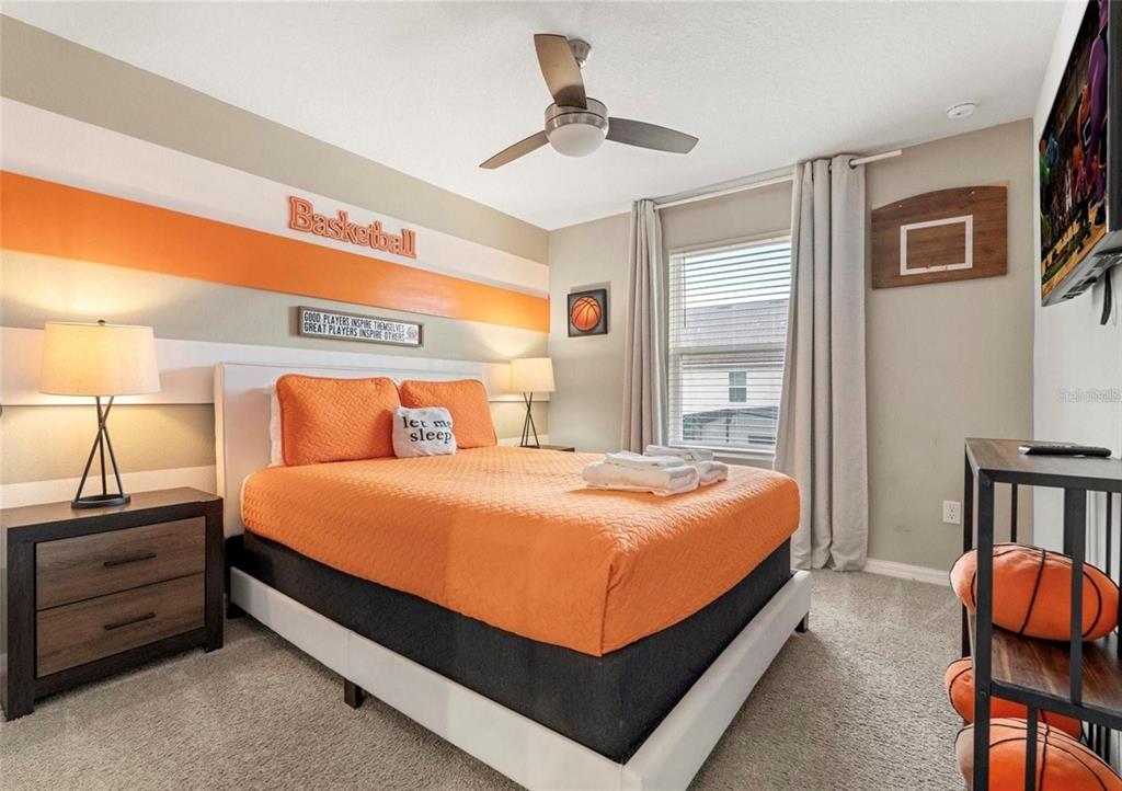 2163 Copper Bell Place Kissimmee, FL 34747 - Photo 24 of 41 a bed sitting in a bedroom next to a window