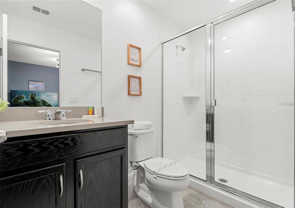 2163 Copper Bell Place Kissimmee, FL 34747 - Photo 27 of 41 a bathroom with a sink a toilet and shower