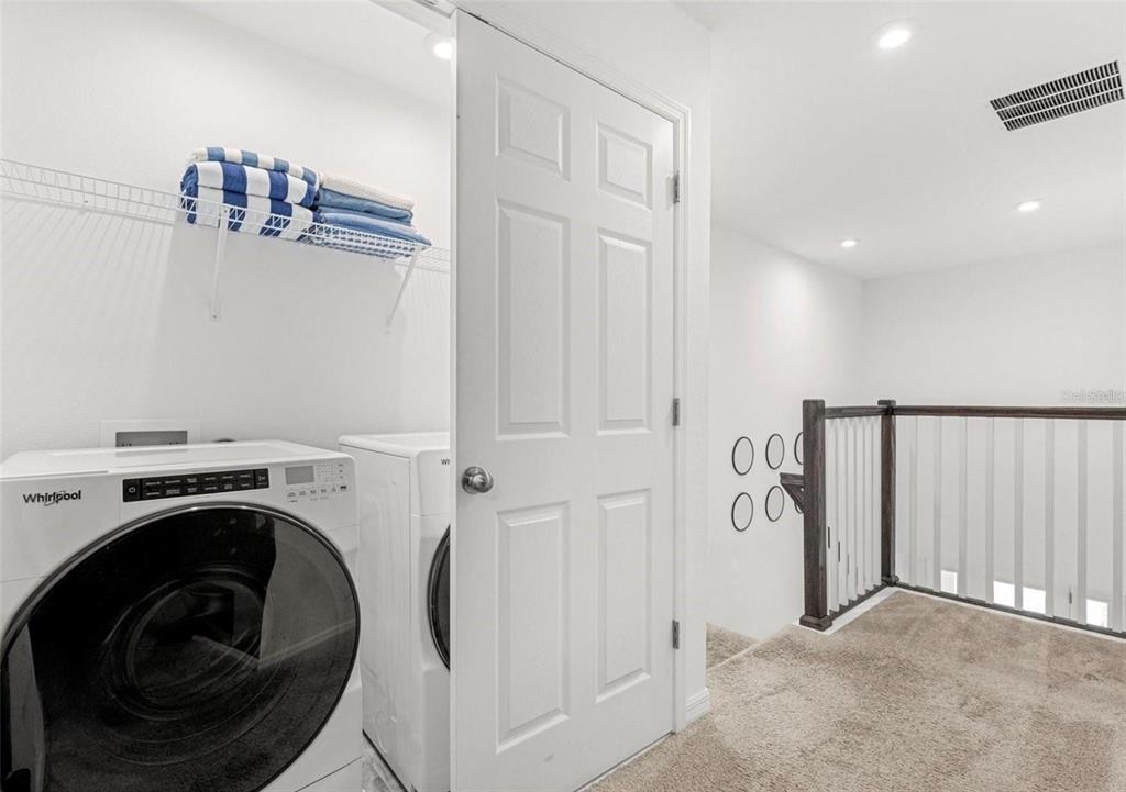 2163 Copper Bell Place Kissimmee, FL 34747 - Photo 30 of 41 a view of a hallway with washer and dryer