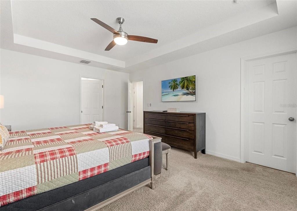 2163 Copper Bell Place Kissimmee, FL 34747 - Photo 32 of 41 a bedroom that has a bed and a painting on the wall