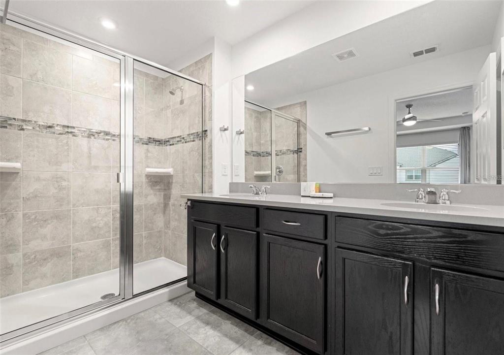 2163 Copper Bell Place Kissimmee, FL 34747 - Photo 34 of 41 a bathroom with a granite countertop sink mirror and double