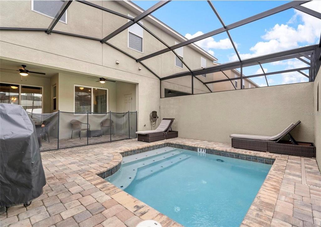 2163 Copper Bell Place Kissimmee, FL 34747 - Photo 38 of 41 a living room with a couch
