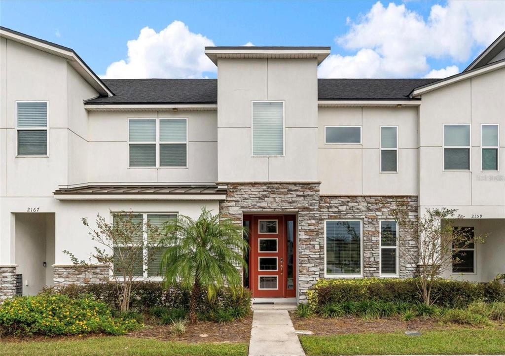 2163 Copper Bell Place Kissimmee, FL 34747 - Photo 4 of 41 a front view of a house with plants