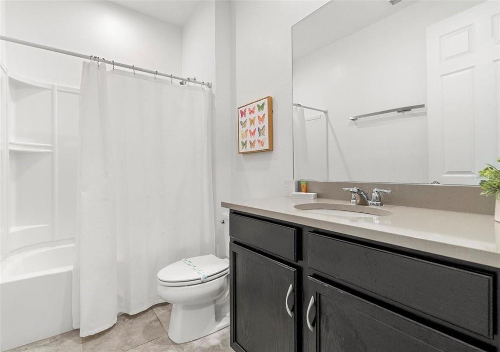 2163 Copper Bell Place Kissimmee, FL 34747 - Photo 7 of 41 a bathroom with a toilet a sink and a bathtub