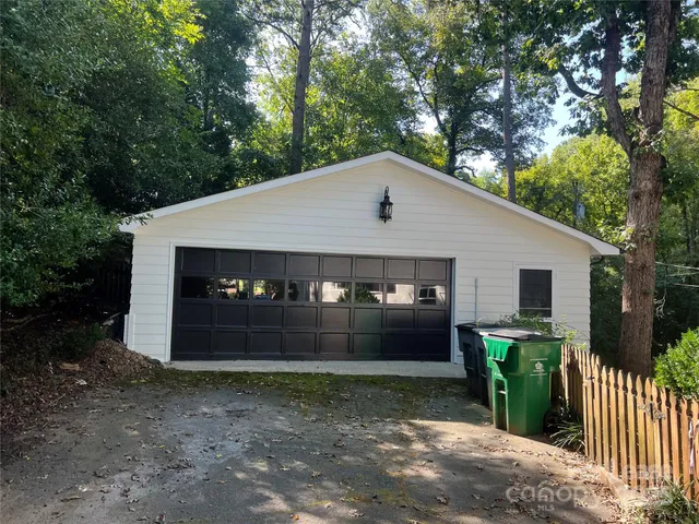 a front view of house with a garden and yard