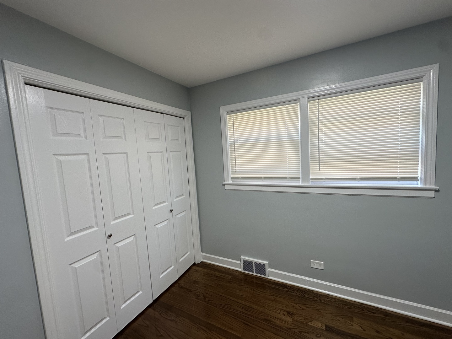 8232 Keating Avenue, Unit 1 Skokie, IL 60076 - Photo 19 of 21 a view of an empty room with wooden floor and a window