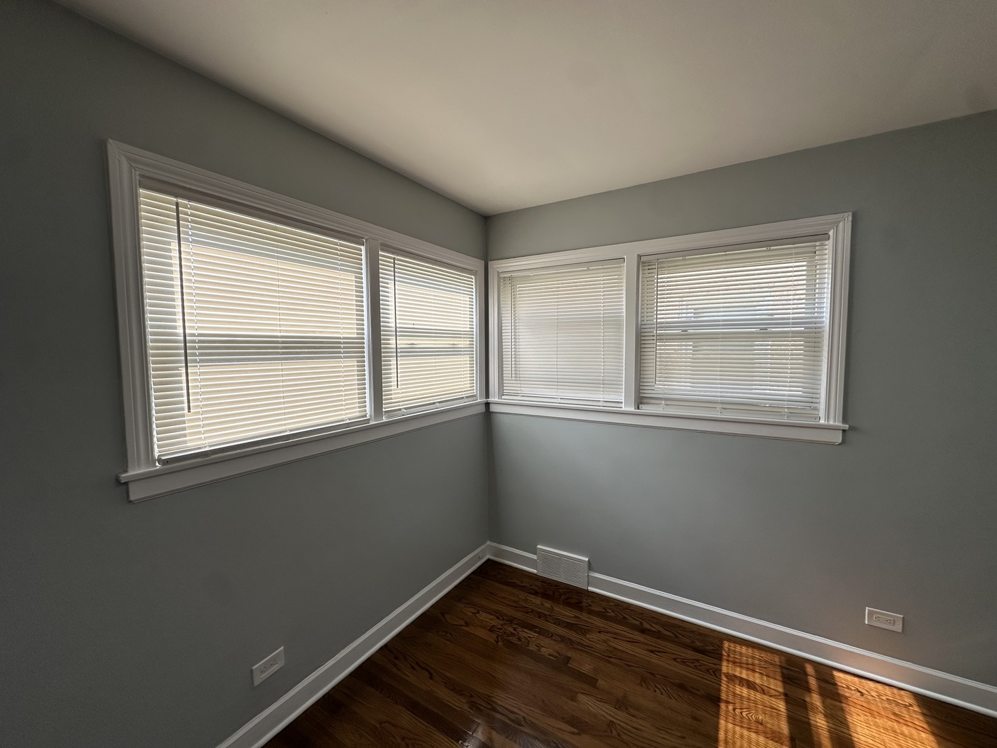 8232 Keating Avenue, Unit 1 Skokie, IL 60076 - Photo 21 of 21 a view of an empty room with wooden floor and a window
