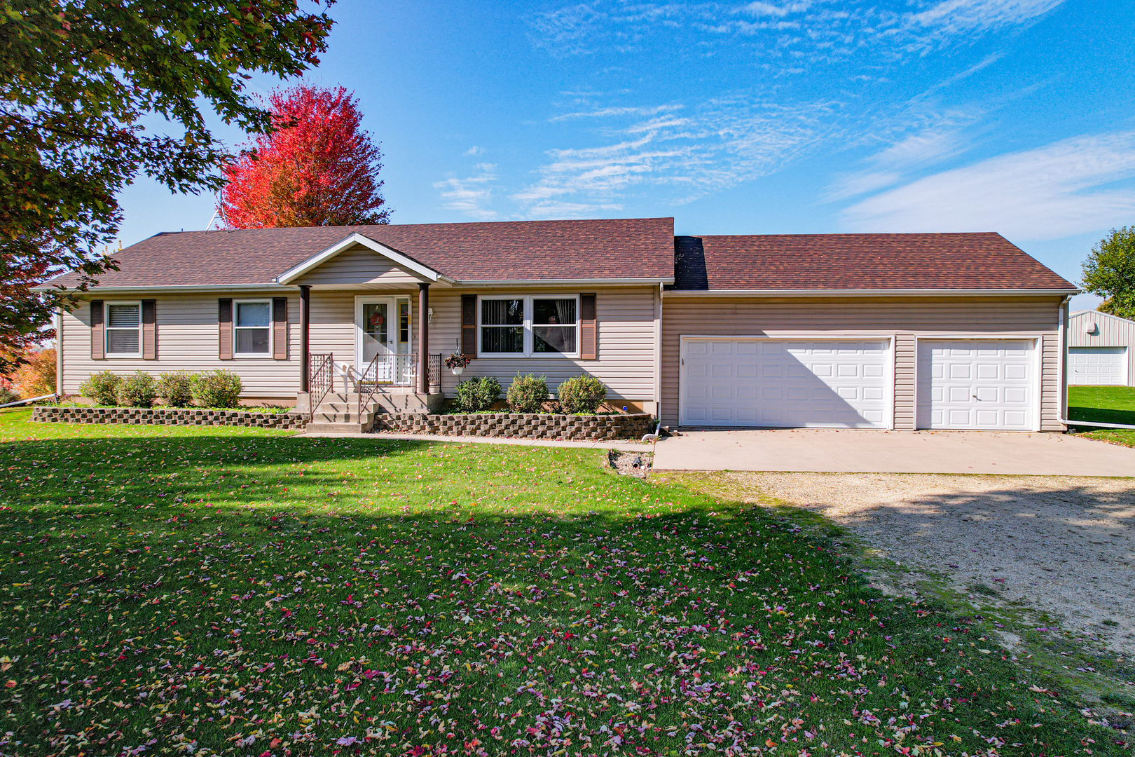 8752 Perryville Road Monroe Center, IL 61052 - Photo 1 of 41 a front view of a house with a garden