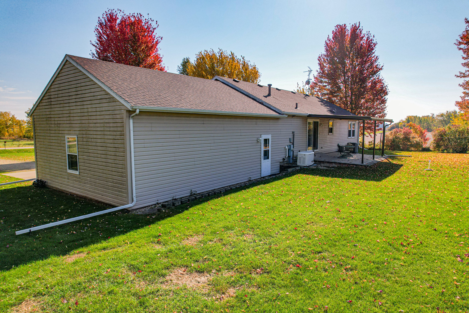 8752 Perryville Road Monroe Center, IL 61052 - Photo 13 of 41 a view of a house with backyard and sitting area