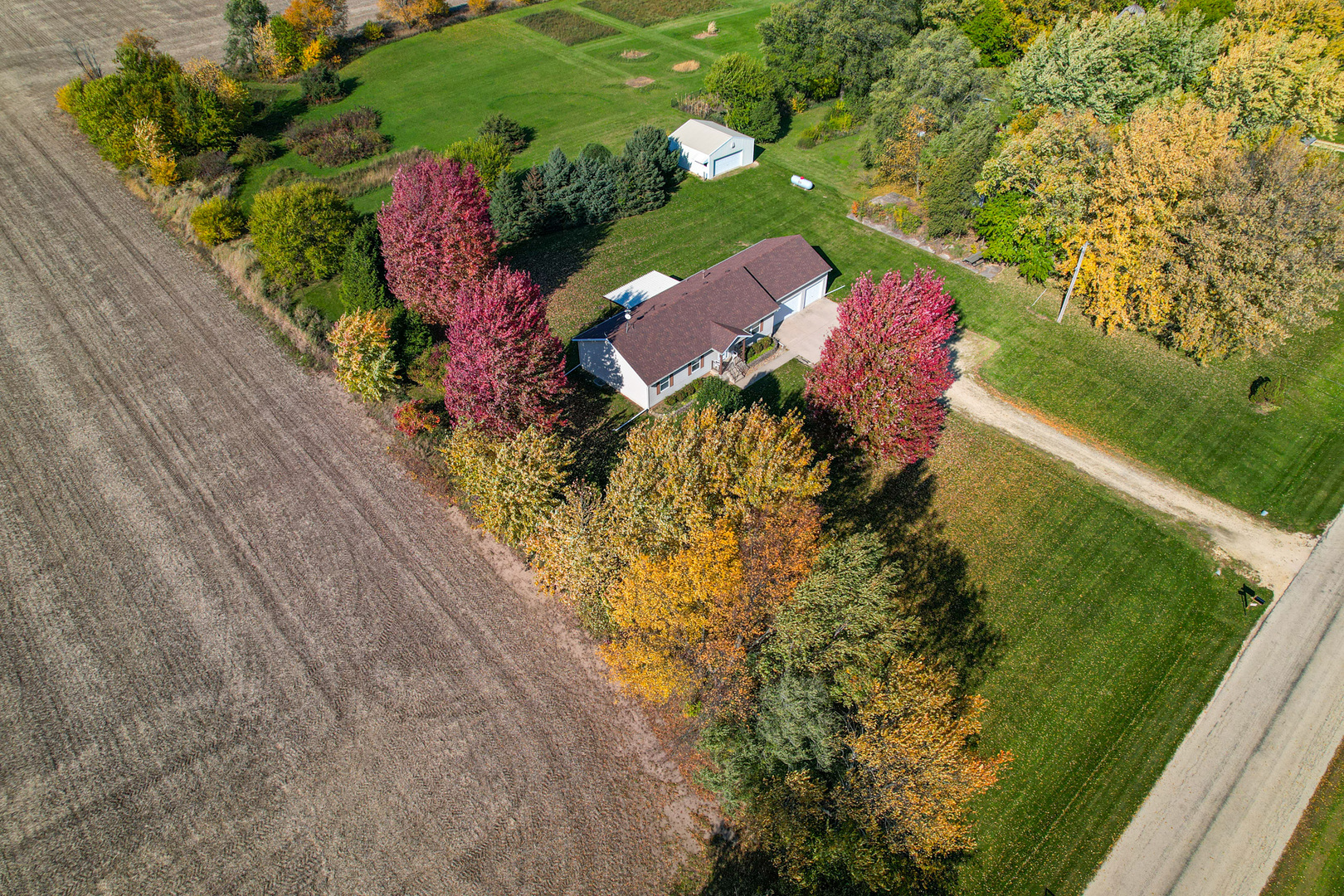 8752 Perryville Road Monroe Center, IL 61052 - Photo 2 of 41 an aerial view of residential house with yard and swimming pool