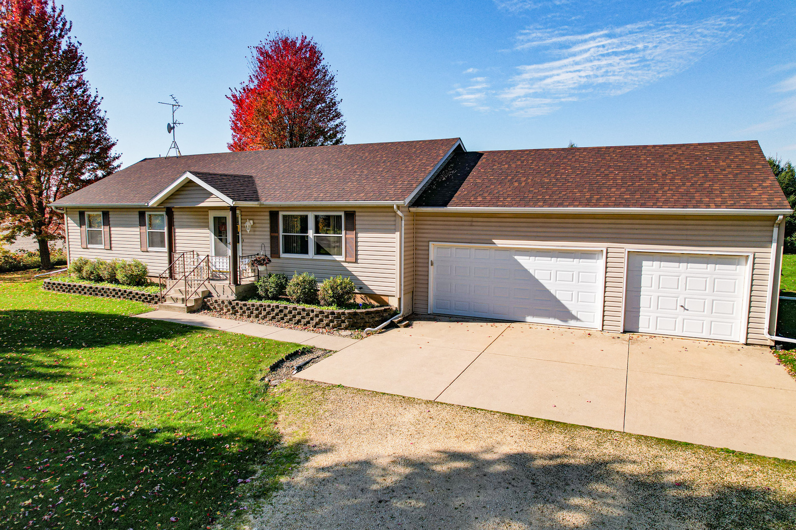 8752 Perryville Road Monroe Center, IL 61052 - Photo 3 of 41 a front view of a house with a yard and garage