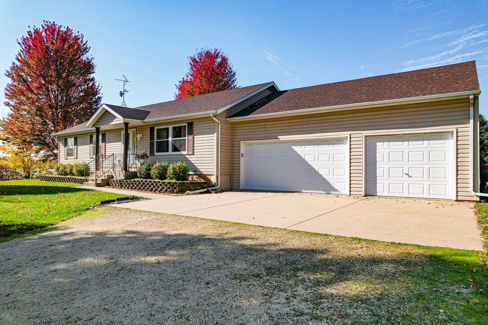 8752 Perryville Road Monroe Center, IL 61052 - Photo 5 of 41 a front view of a house with a yard and garage