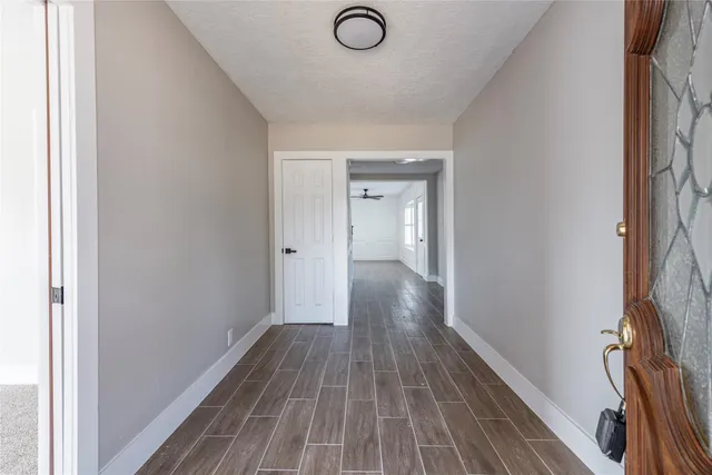 a view of a room with wooden floor