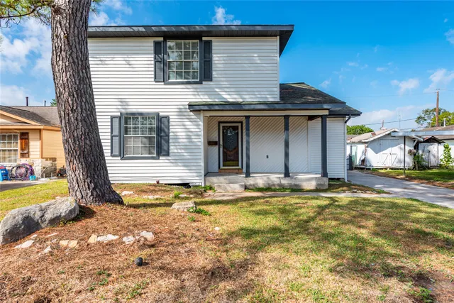 a view of a house with swimming pool and sitting area