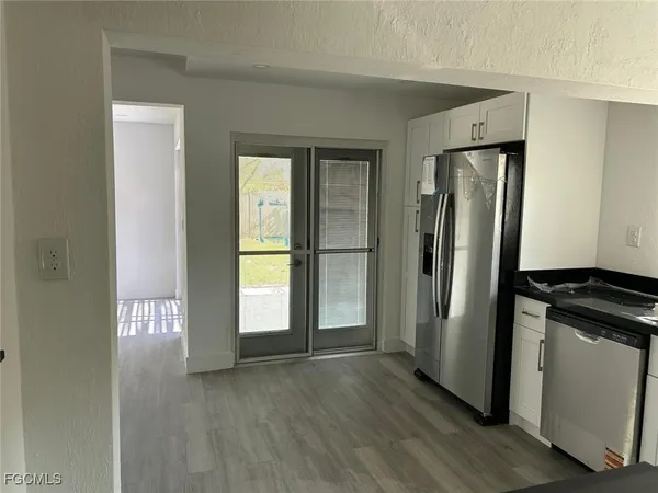 an empty room with wooden floor and a window