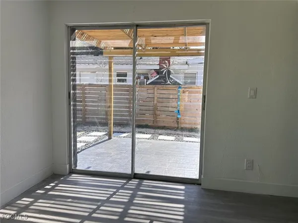 a view of a room with wooden floor and windows