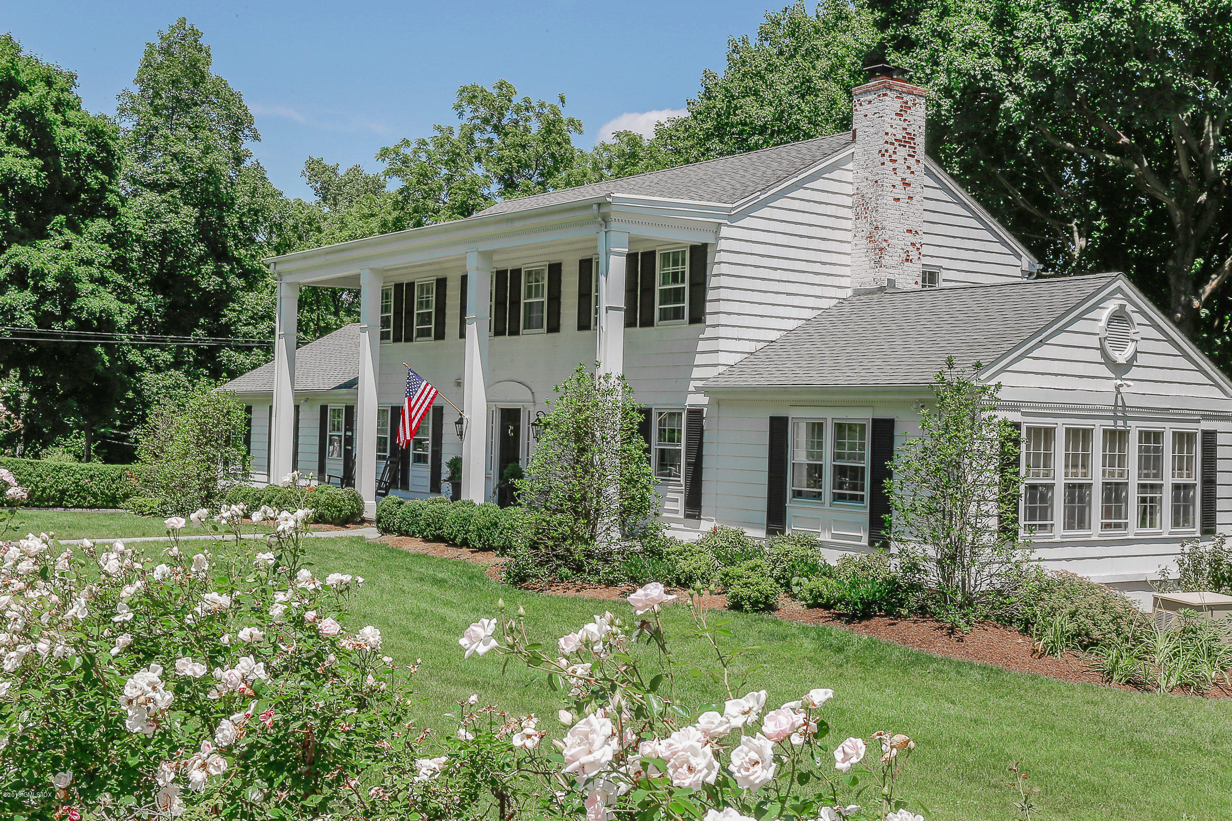 18 Dingletown Road Greenwich, CT 06830 - Photo 1 of 21 a front view of a house with a yard and potted plants