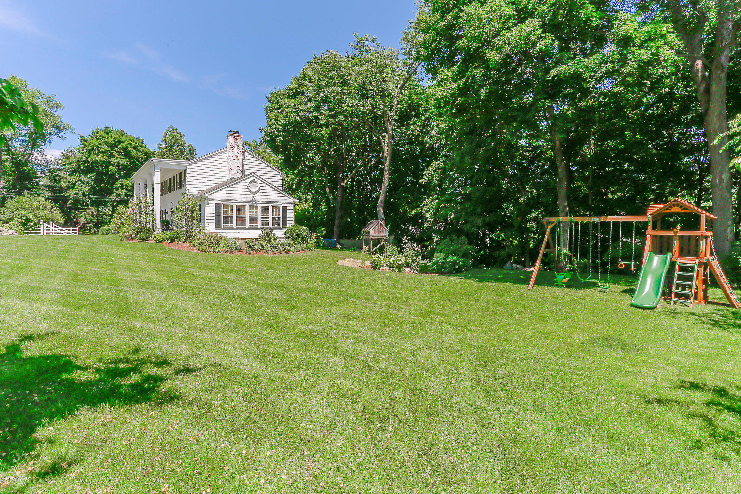 18 Dingletown Road Greenwich, CT 06830 - Photo 15 of 21 a view of a house with a backyard and a slide