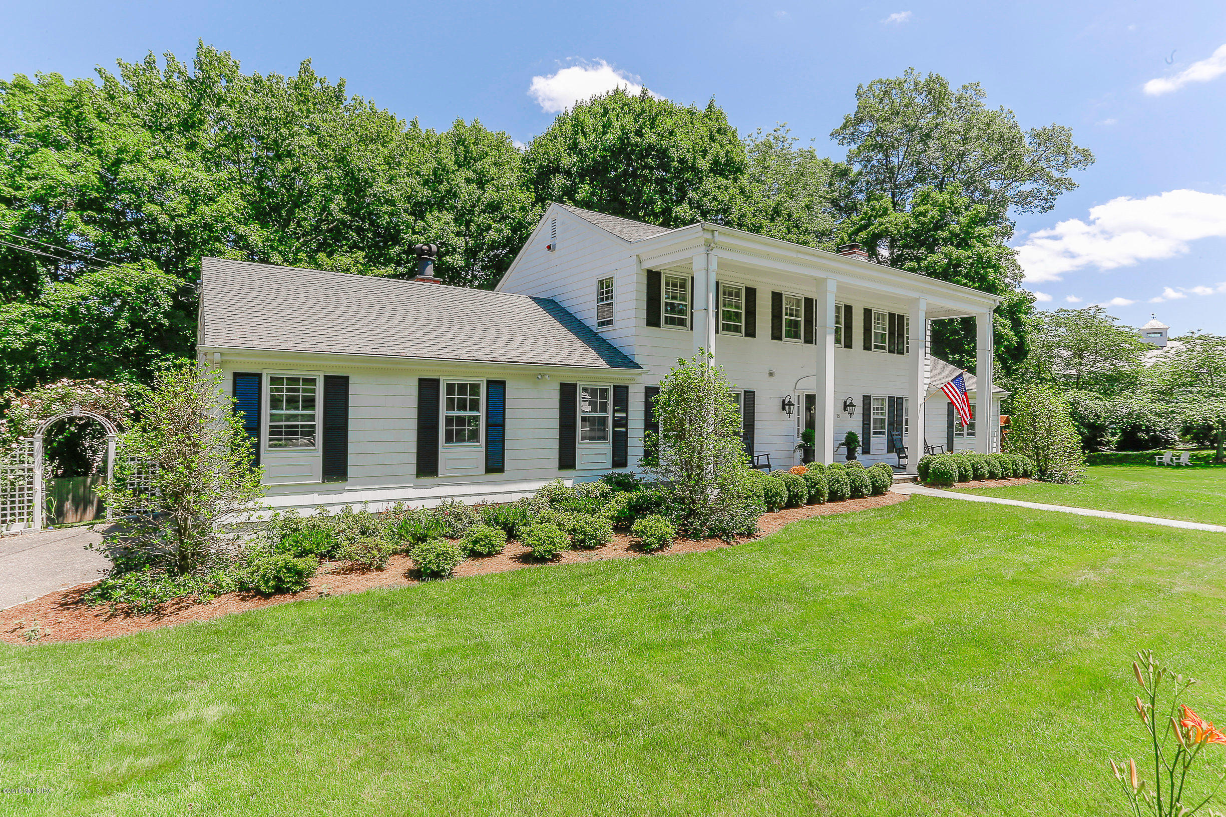 18 Dingletown Road Greenwich, CT 06830 - Photo 18 of 21 a front view of a house with a garden and plants