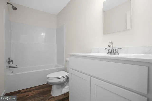 a bathroom with a shower a toilet and a sink